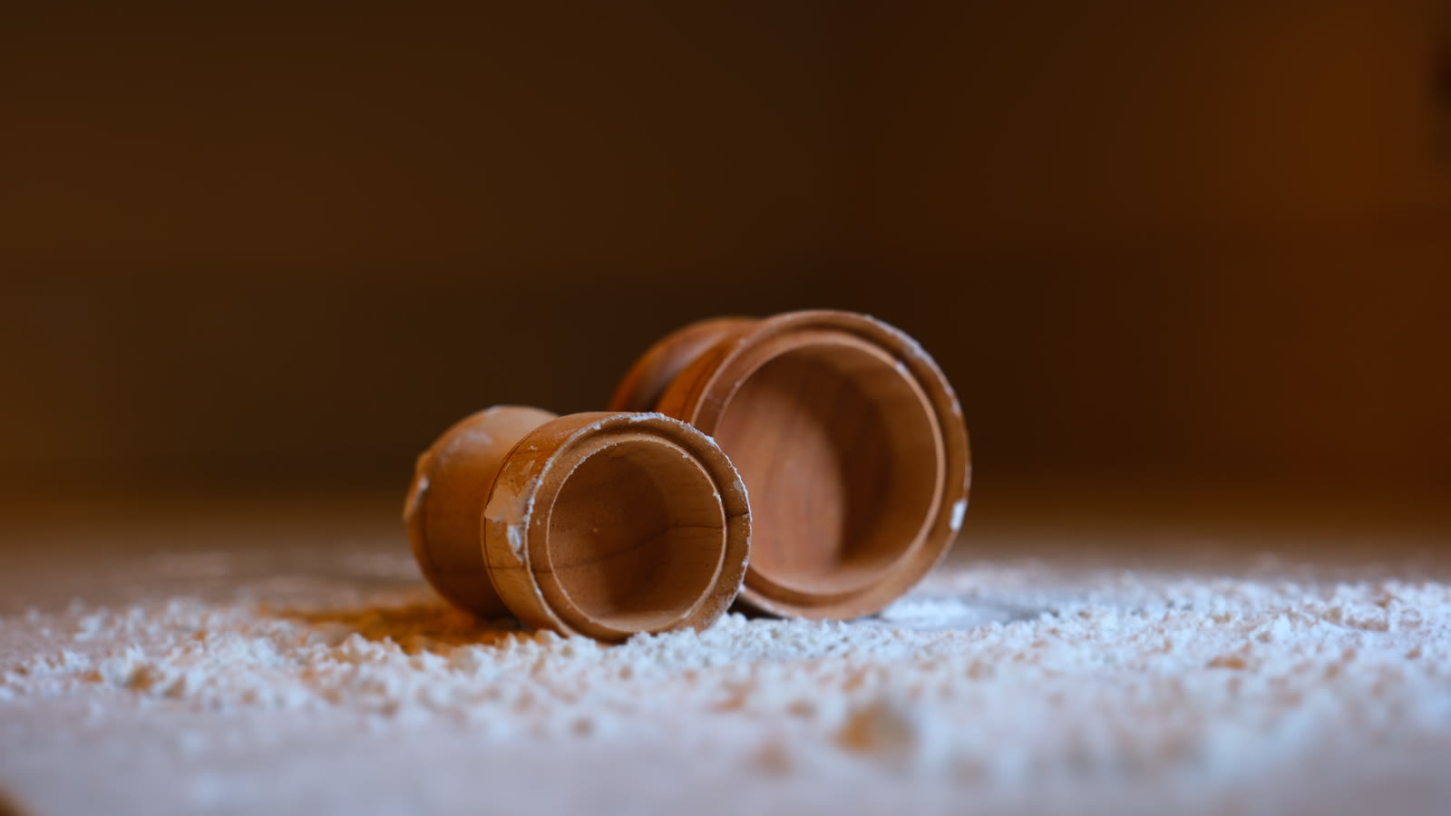 Both STAMPLING maple stamps resting in flour, showing the round pressing faces